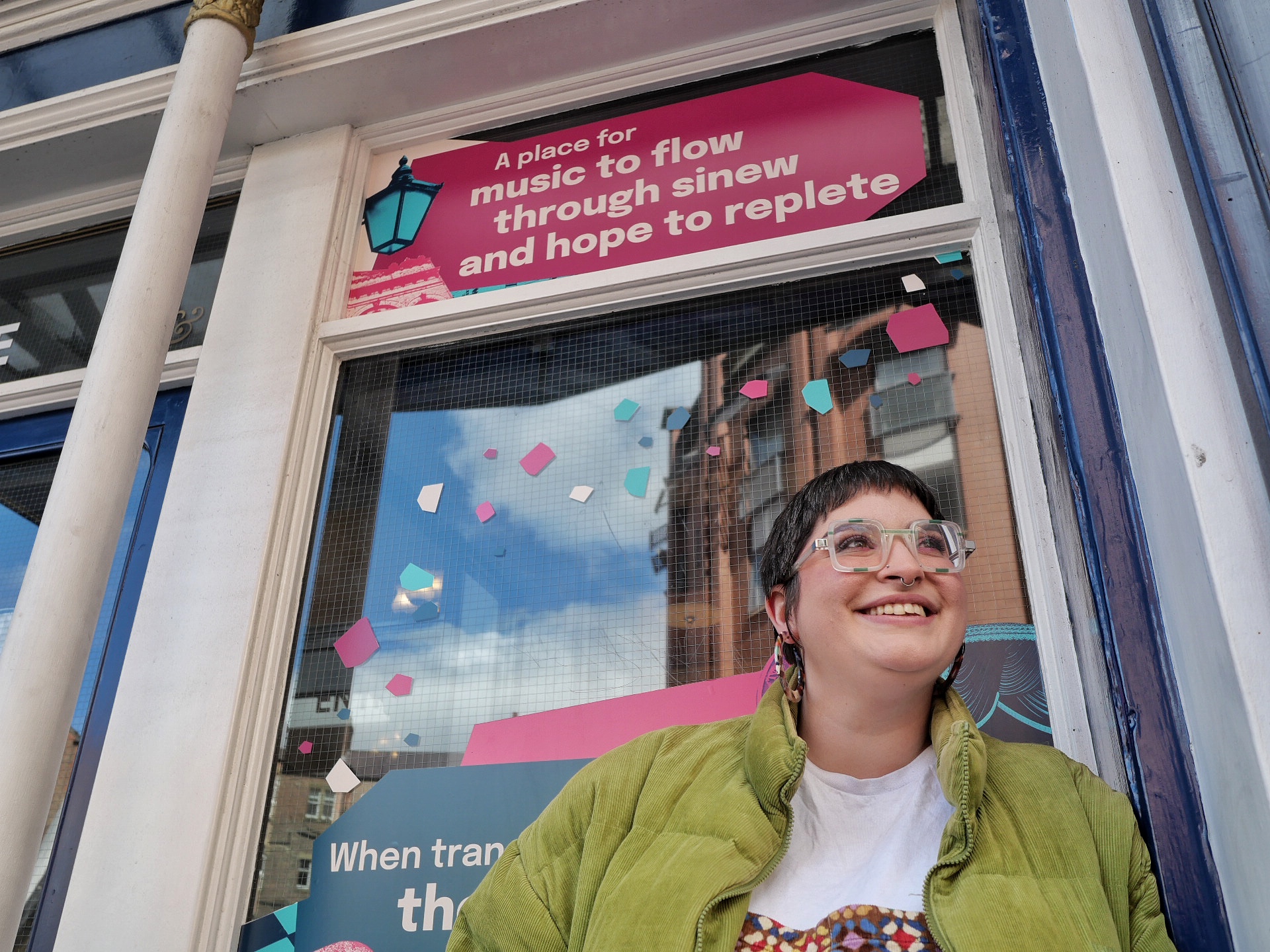 Amy in front of a poem decal on Tyne Theatre and Opera House