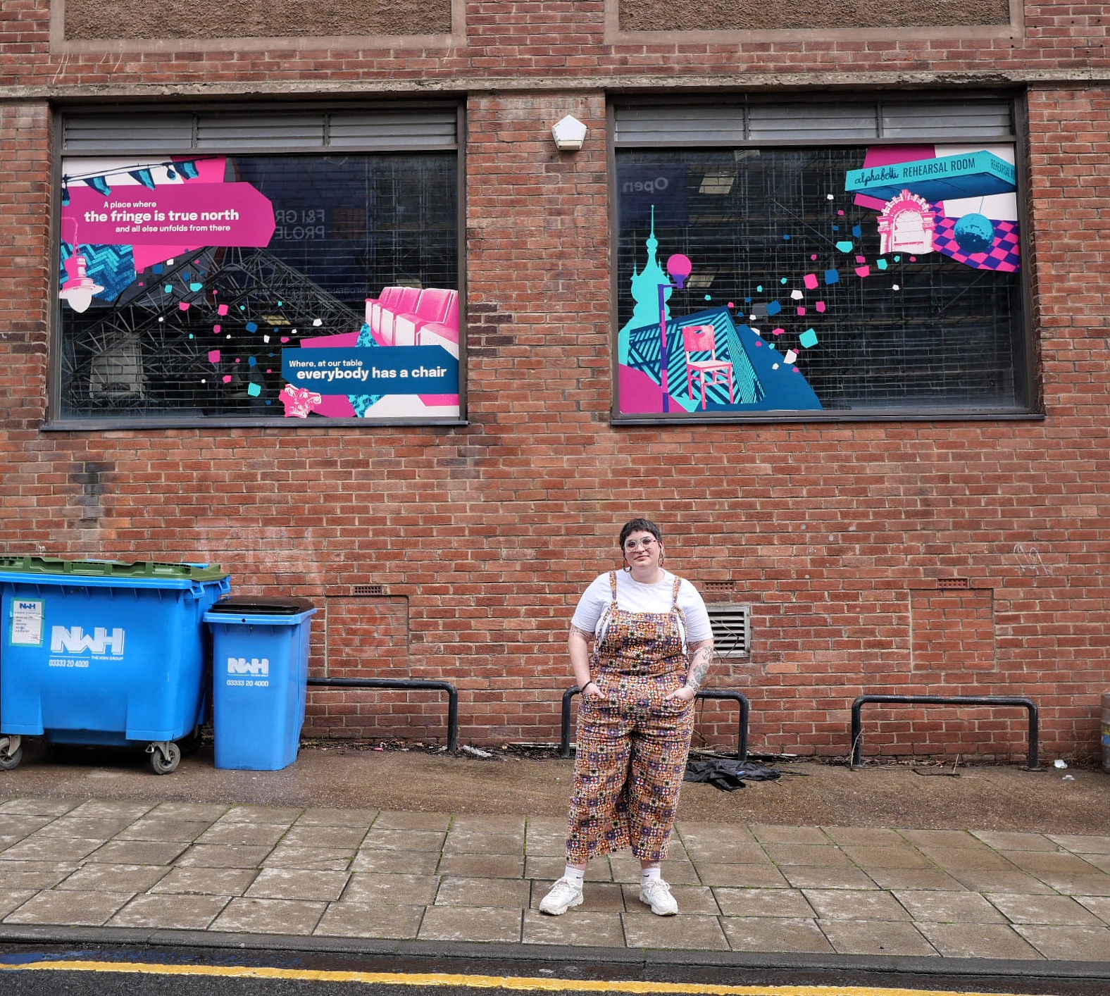 Amy standing in front of a poetry decal at Alphabetti Theatre